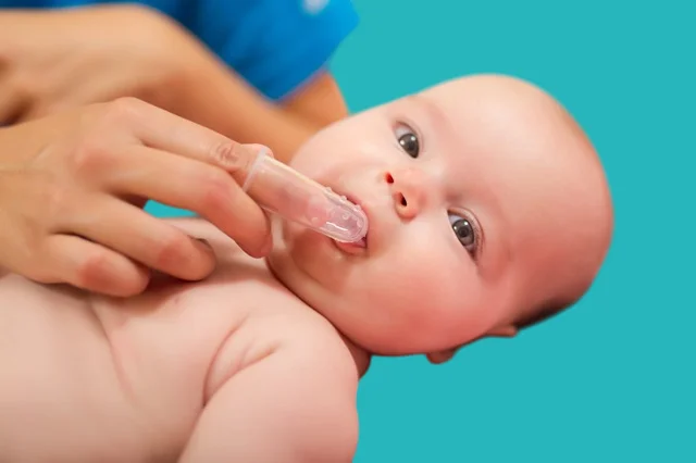Massaging the gums to relieve teething pain in infants