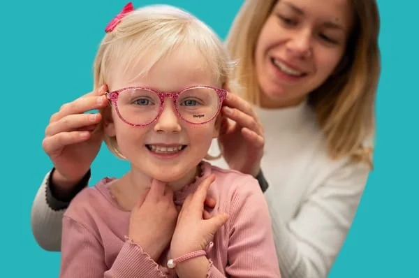 Wearing eyeglasses to treat farsightedness in children