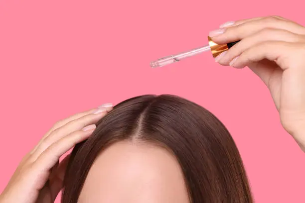 Applying the serum to the scalp